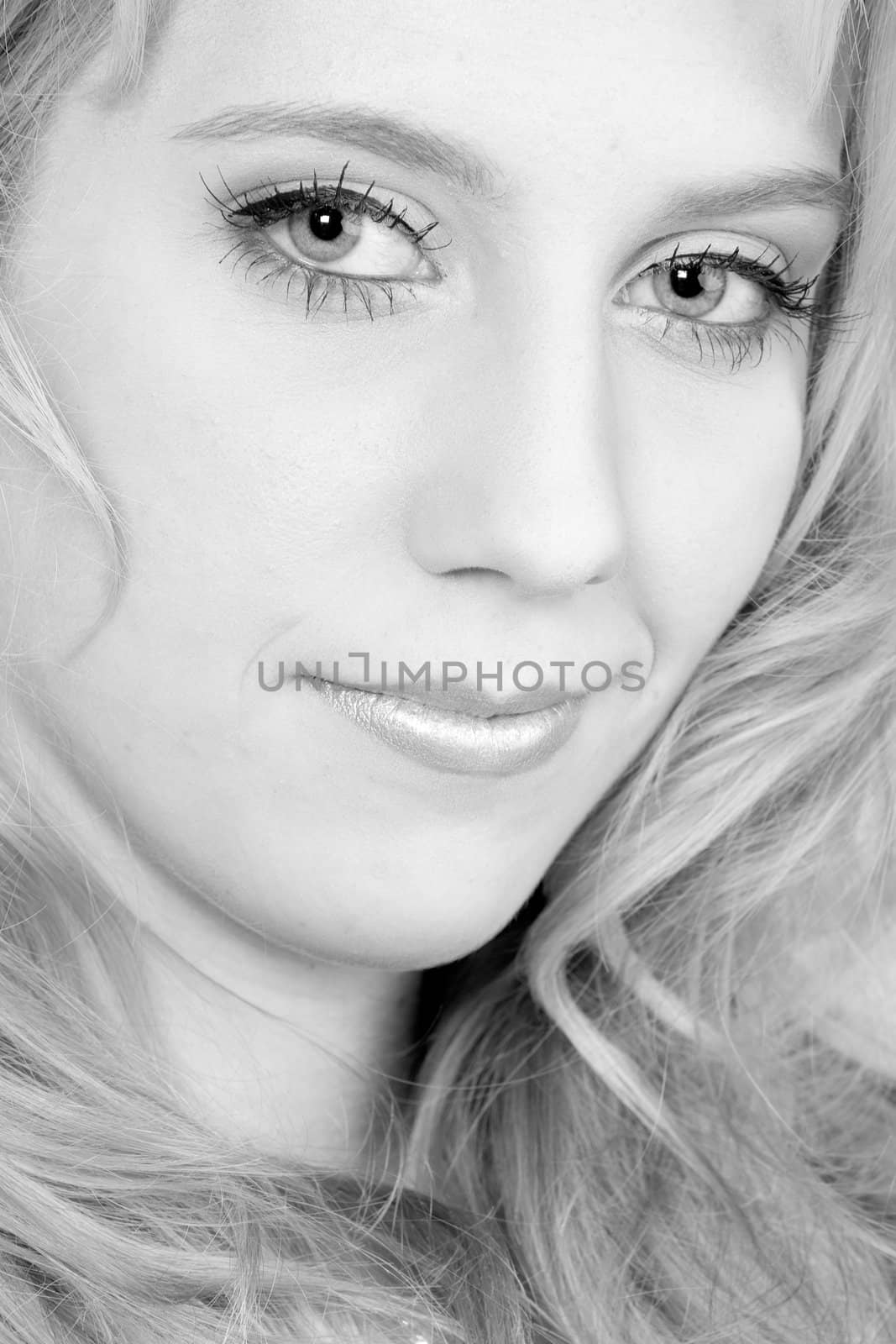 Studio portrait of a long blond girl looking mesmerised