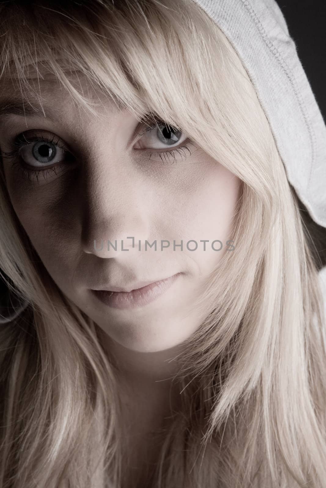 Studio portrait of a long blond girl in pain