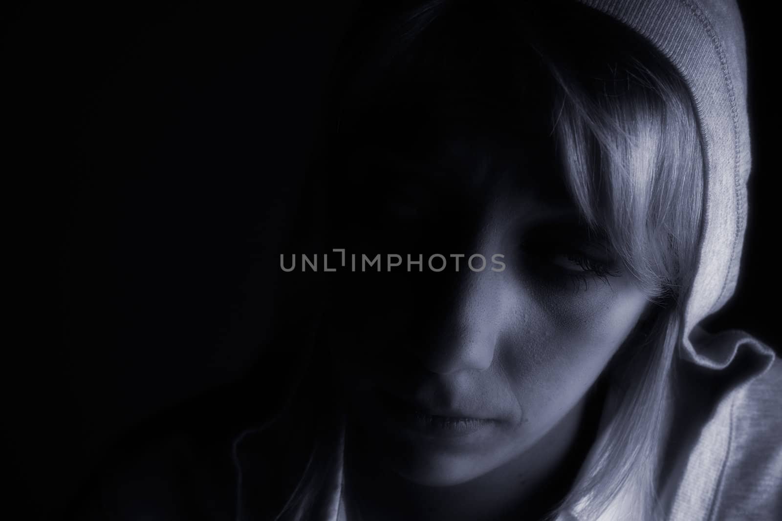 Studio portrait of a long blond girl in the dark by DNFStyle