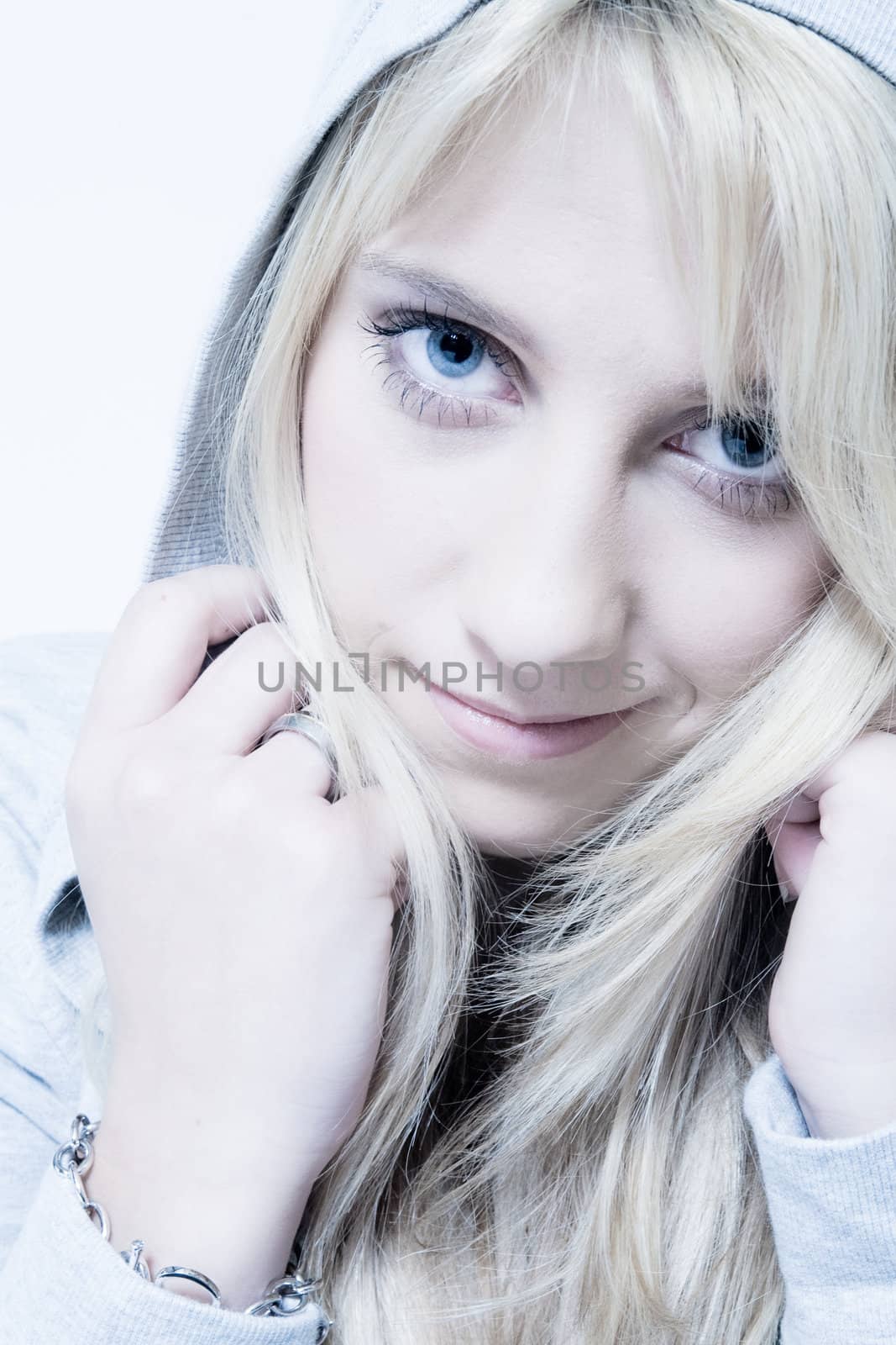 Studio portrait of a long blond girl looking friendly