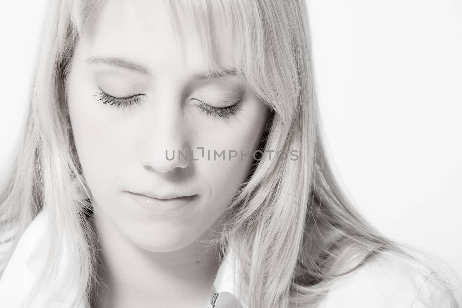 Studio portrait of a long blond girl looking relaxed