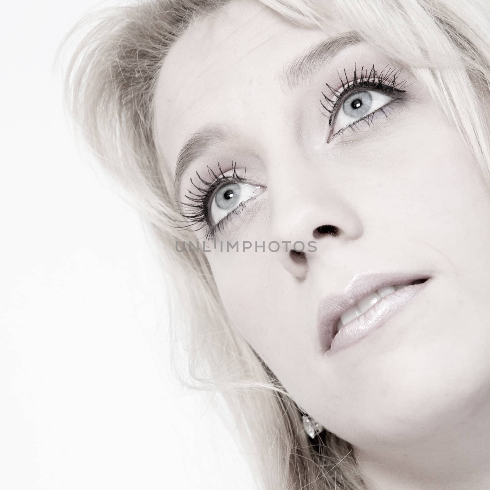 Studio portrait of a long blond girl looking up by DNFStyle