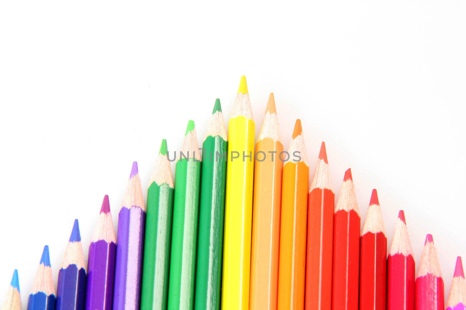 colorful arrow made of pencils isolated on white background