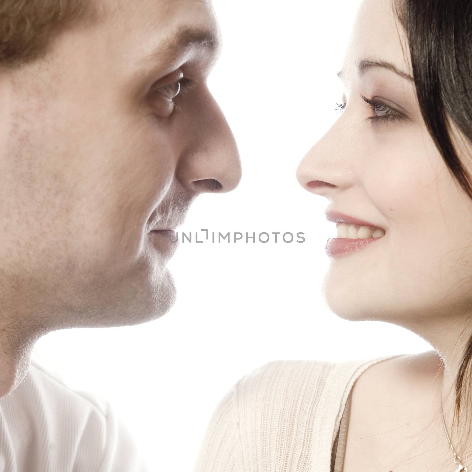 Studio portrait of a young couple looking at each other