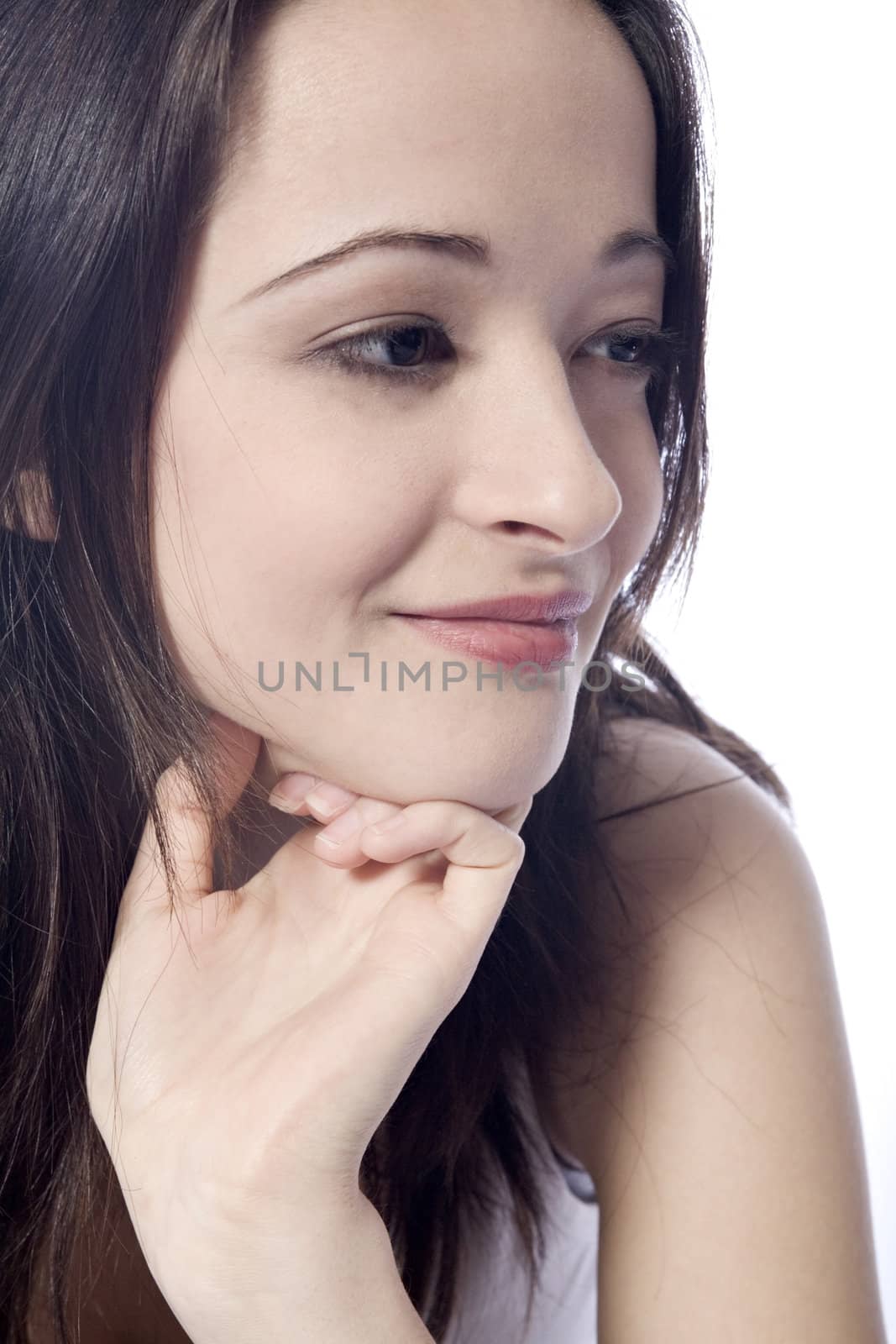 Studio portrait of pretty brunette looking concentrated