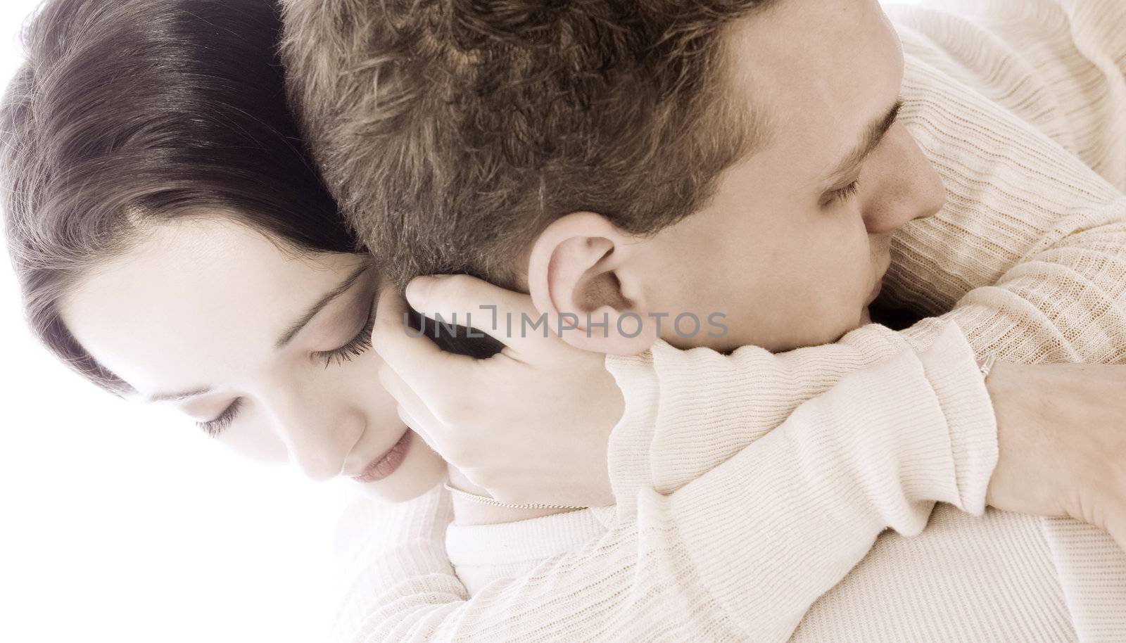 Studio portrait of a young couple cuddling