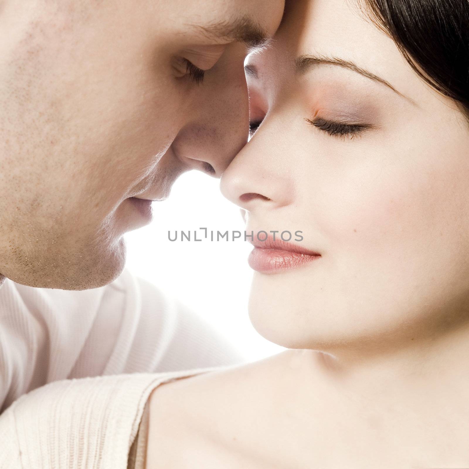 Studio portrait of pretty young couple in love