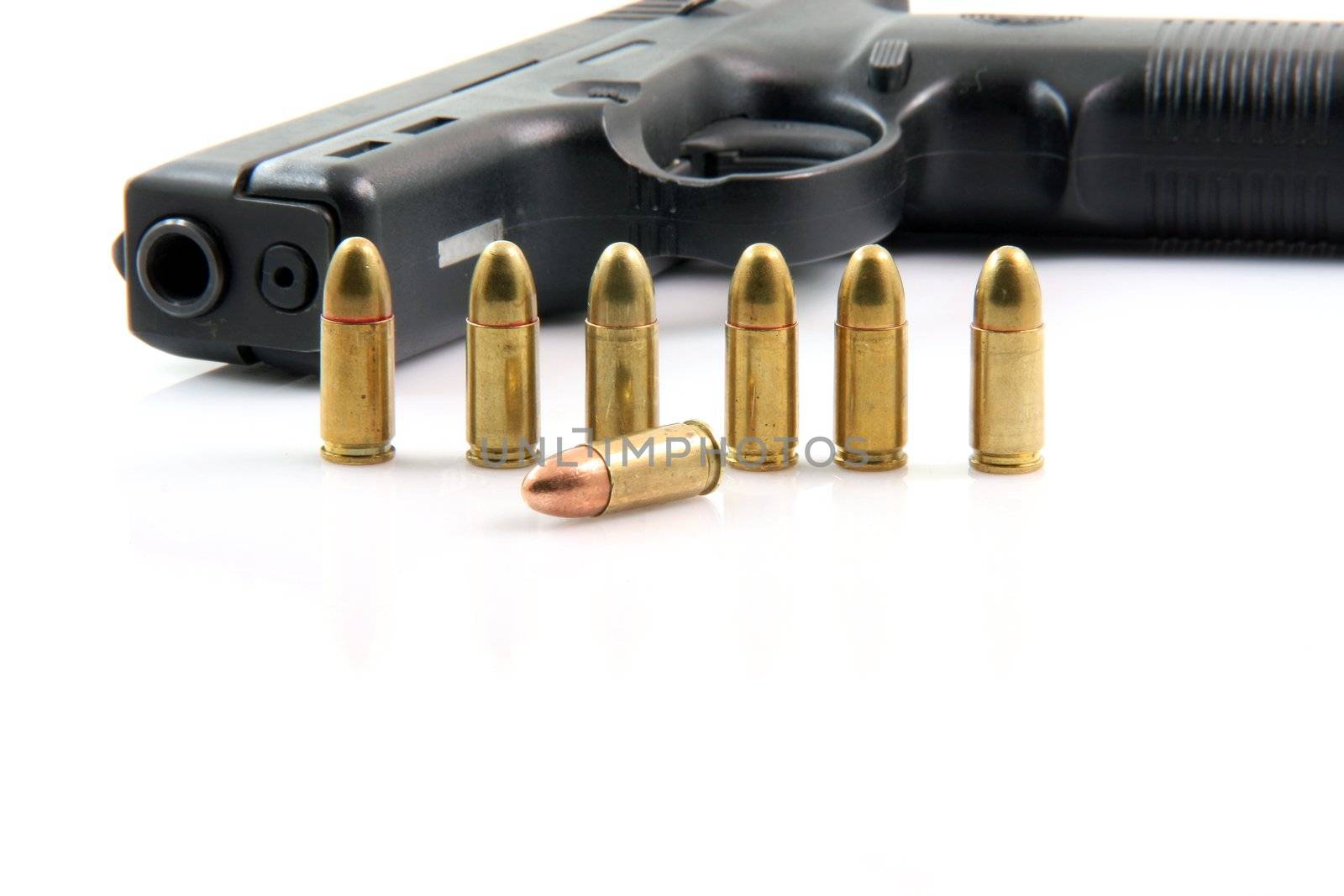 seven bullets and handgun closeup isolated on white background