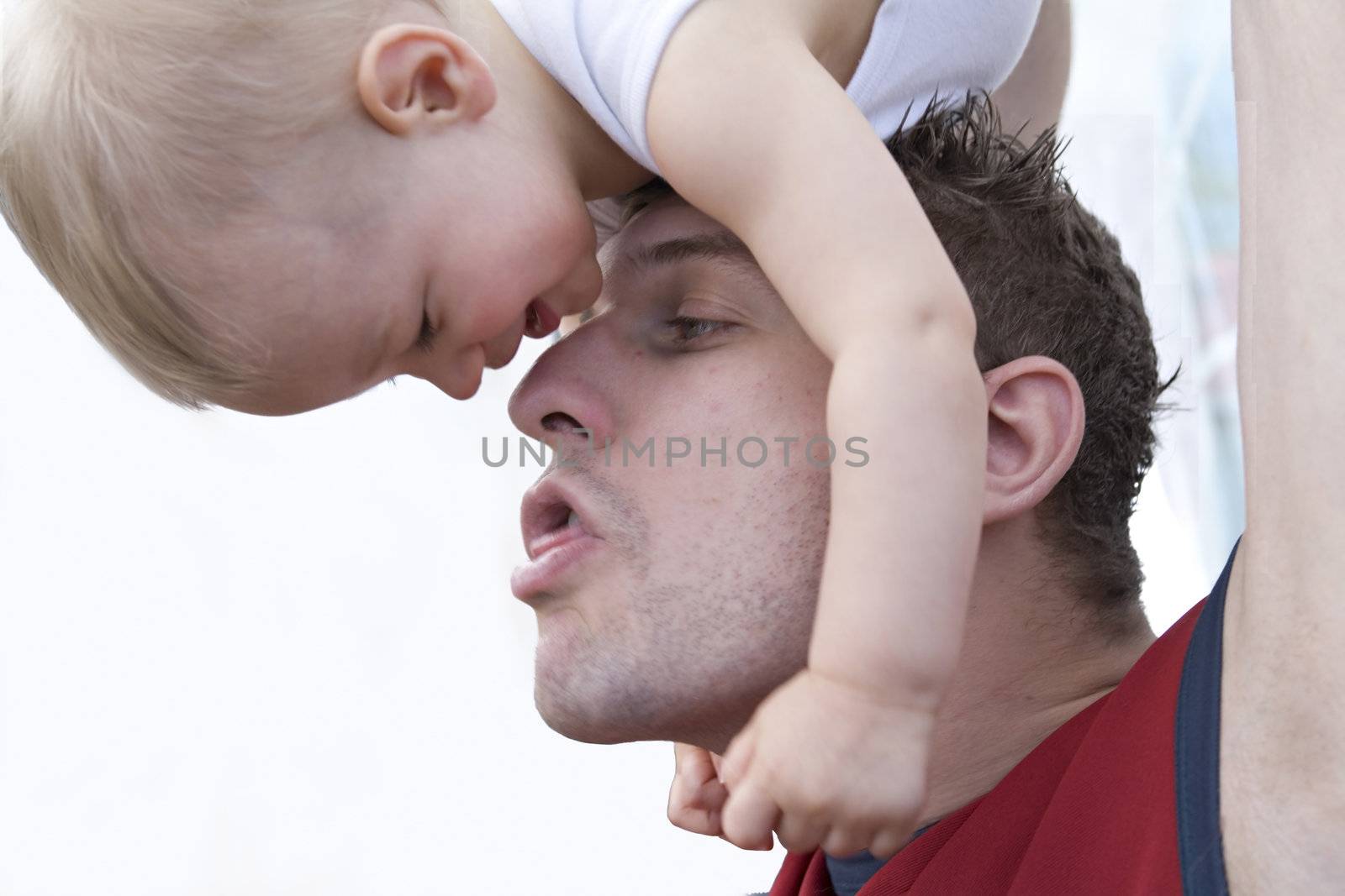 Studio portrait of a young father making jokes with his son