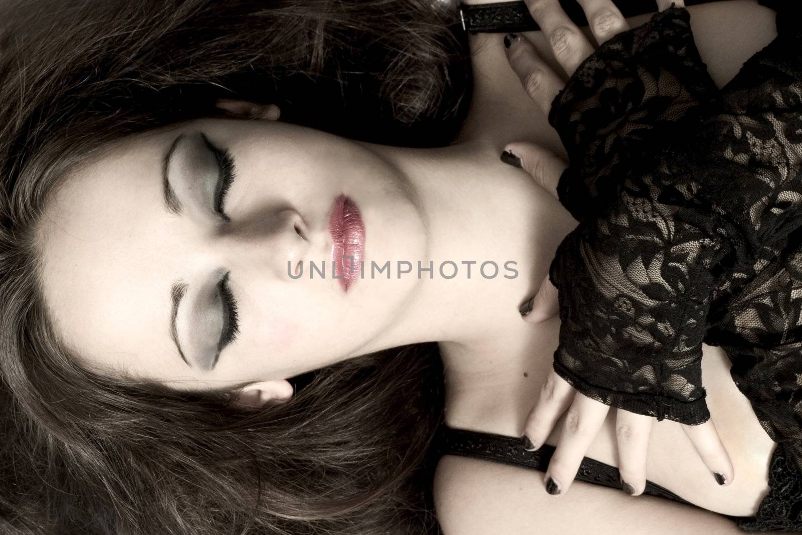 Studio portrait of pretty brunette sleeping