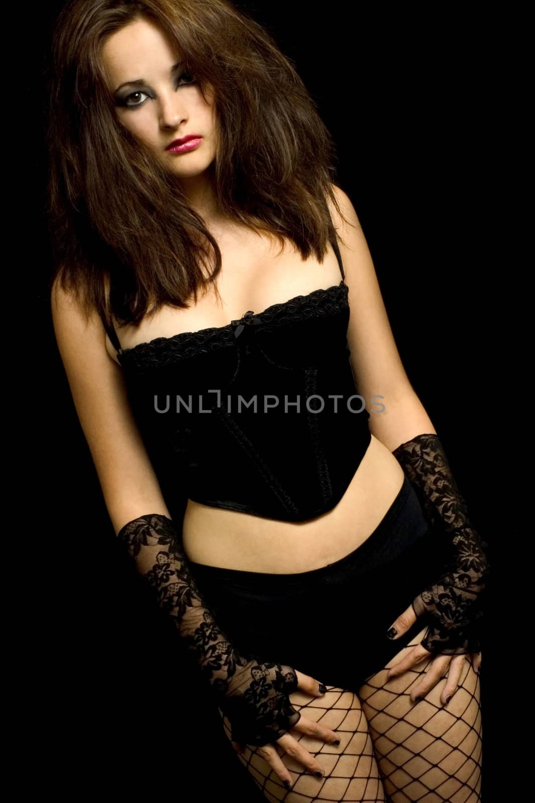 Studio portrait of pretty brunette in corsette