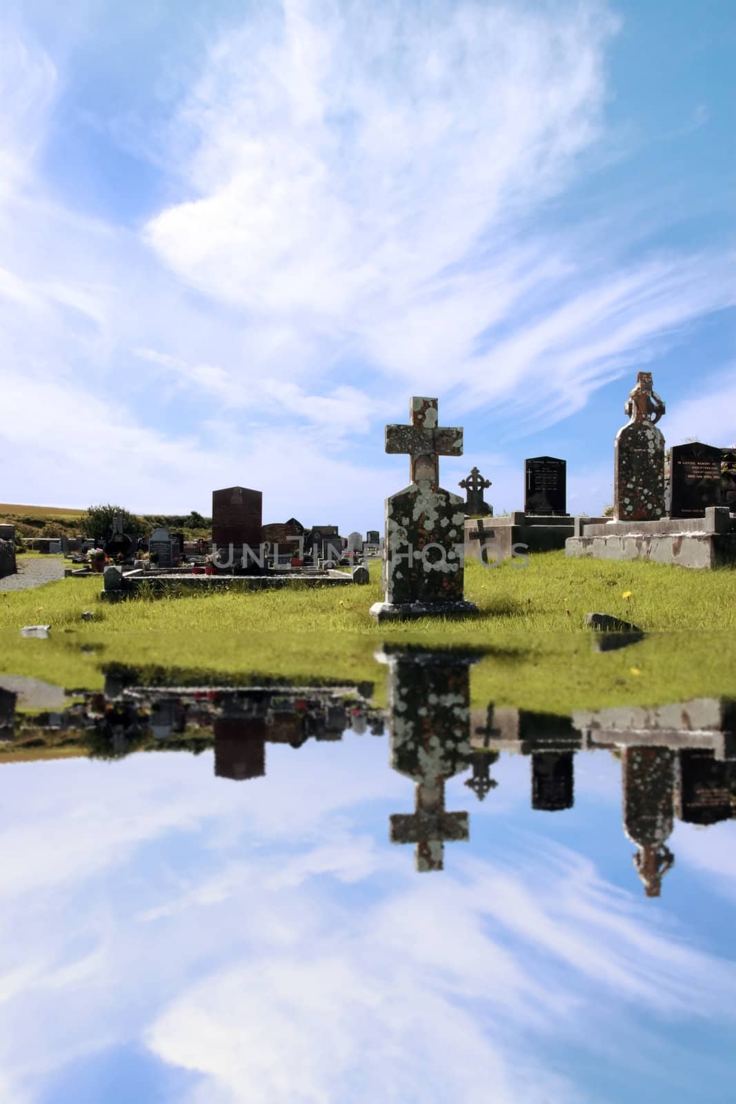 an old irish graveyard in Kerry on the west coast of Ireland reflected in water