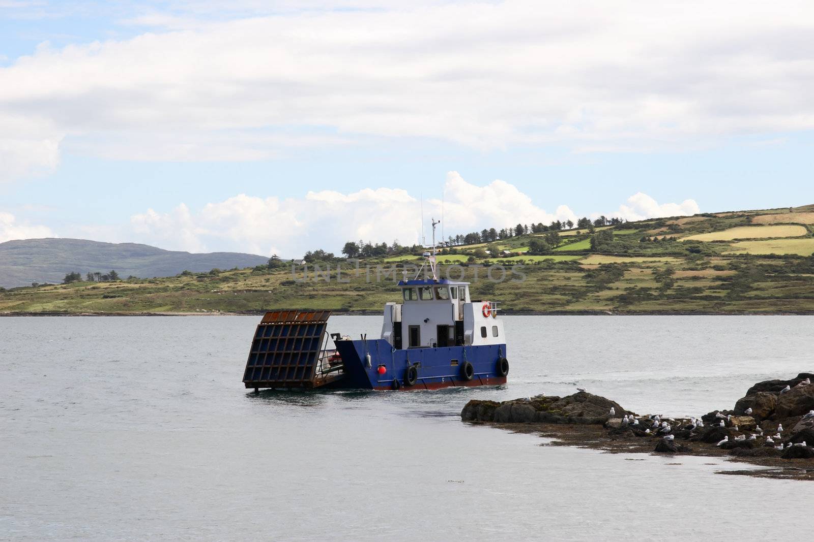 a small island car ferry coming in to dock in county cork ireland