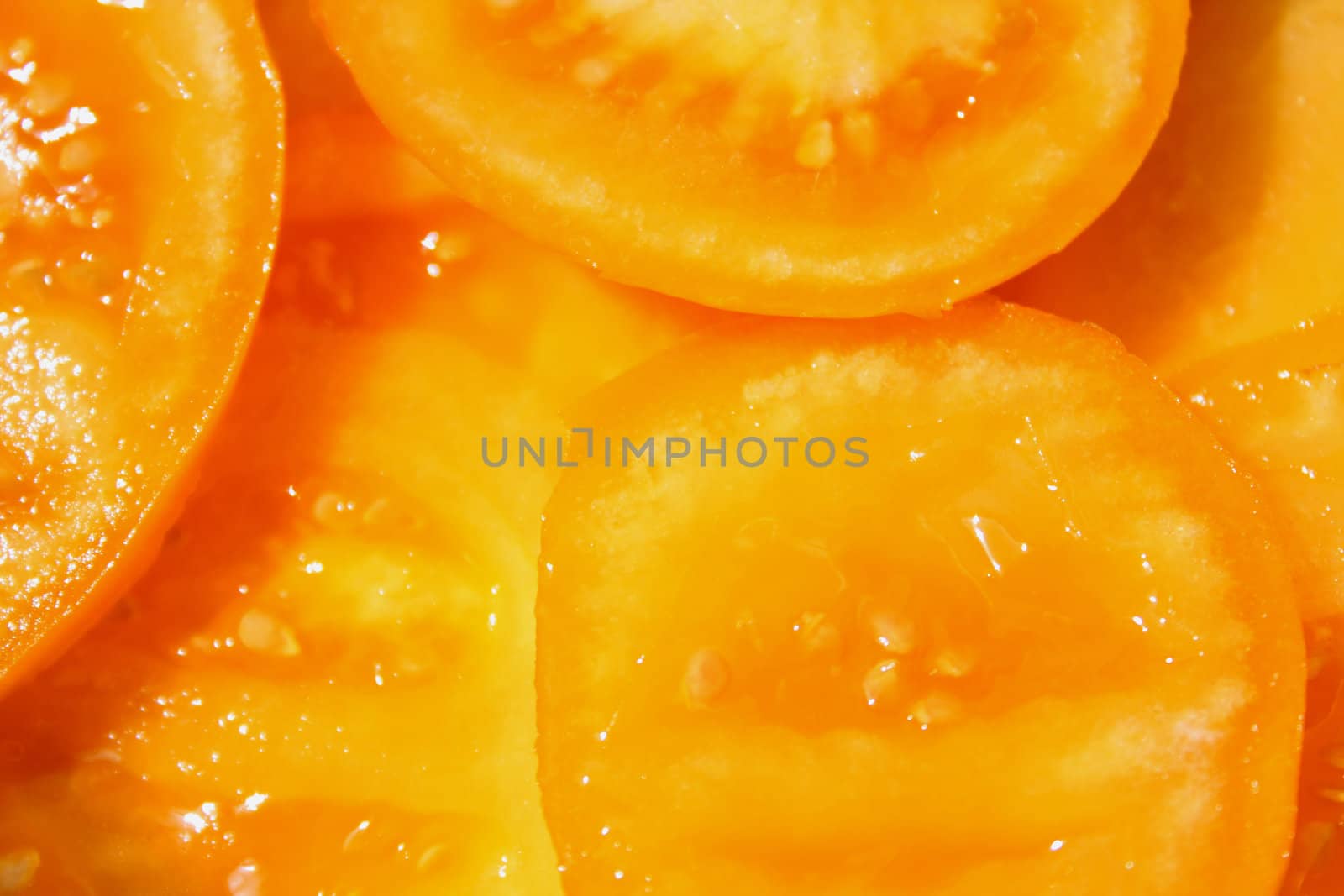 Close up of the yellow sliced tomatoes. Background.