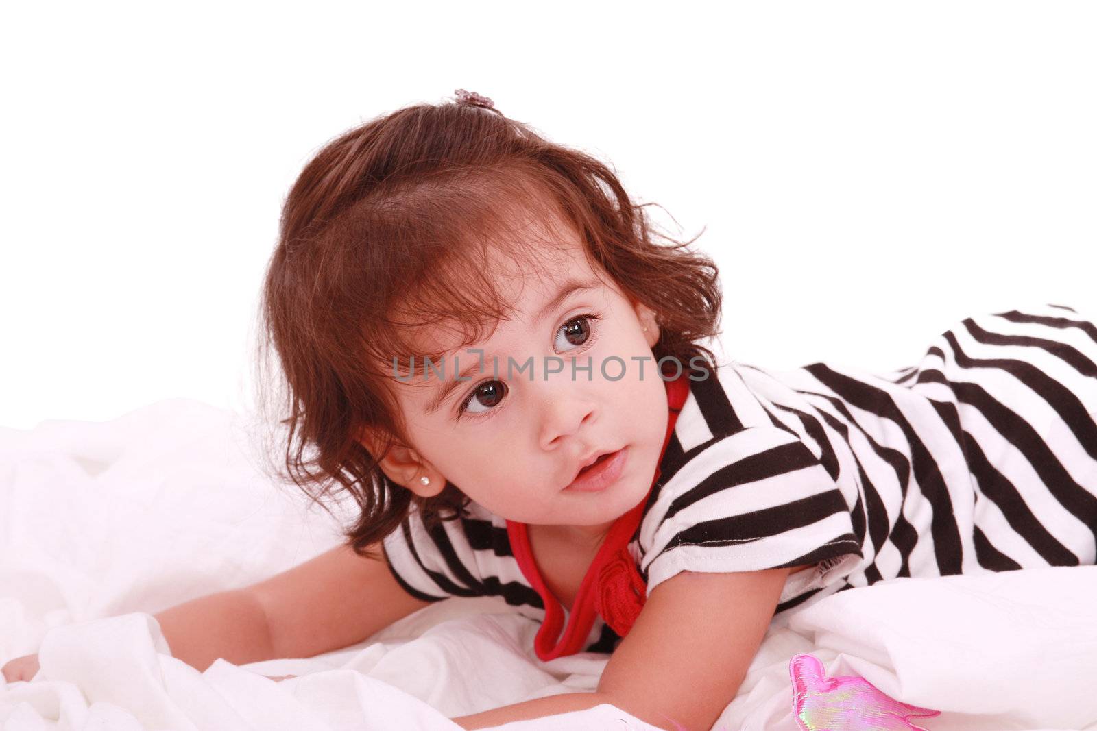 baby girl lying on the bed with swimsuit with space for advertising