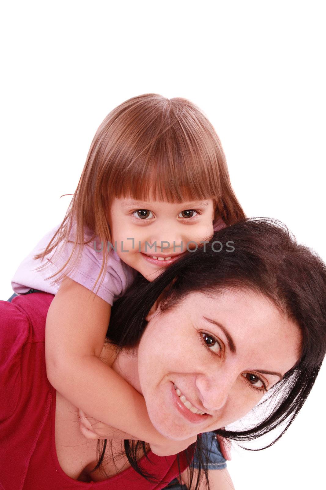 Mother and daughter smiling into the camera lens