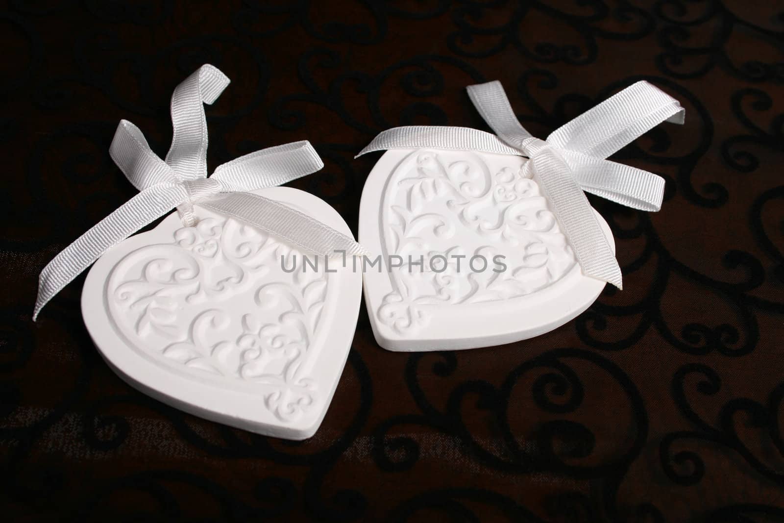 White Ceramic hearts with white ribbons tied