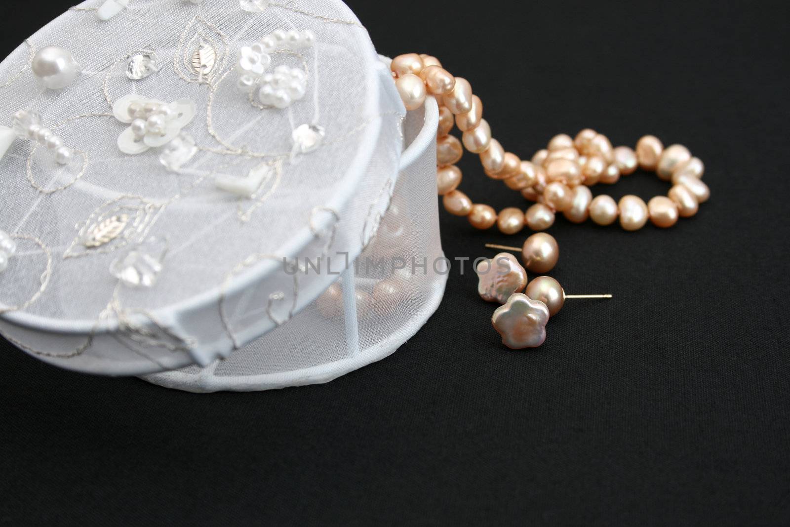 String of pearls and earrings with a jewelery box