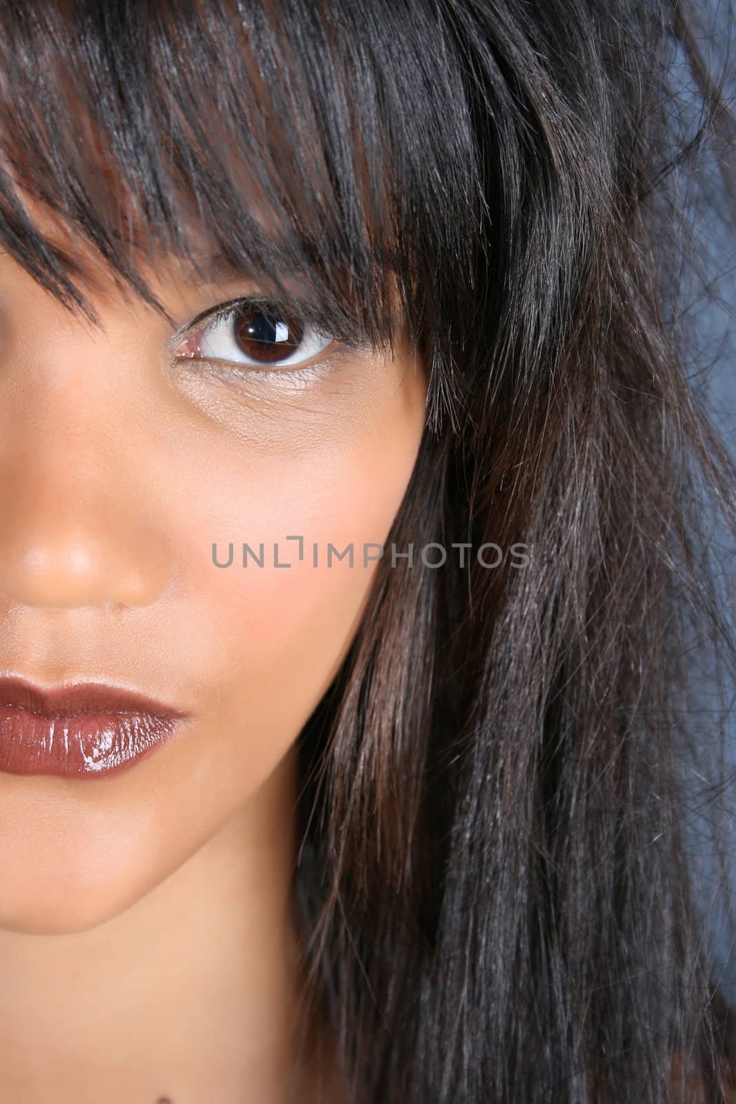 Beautiful young female model against a blue background