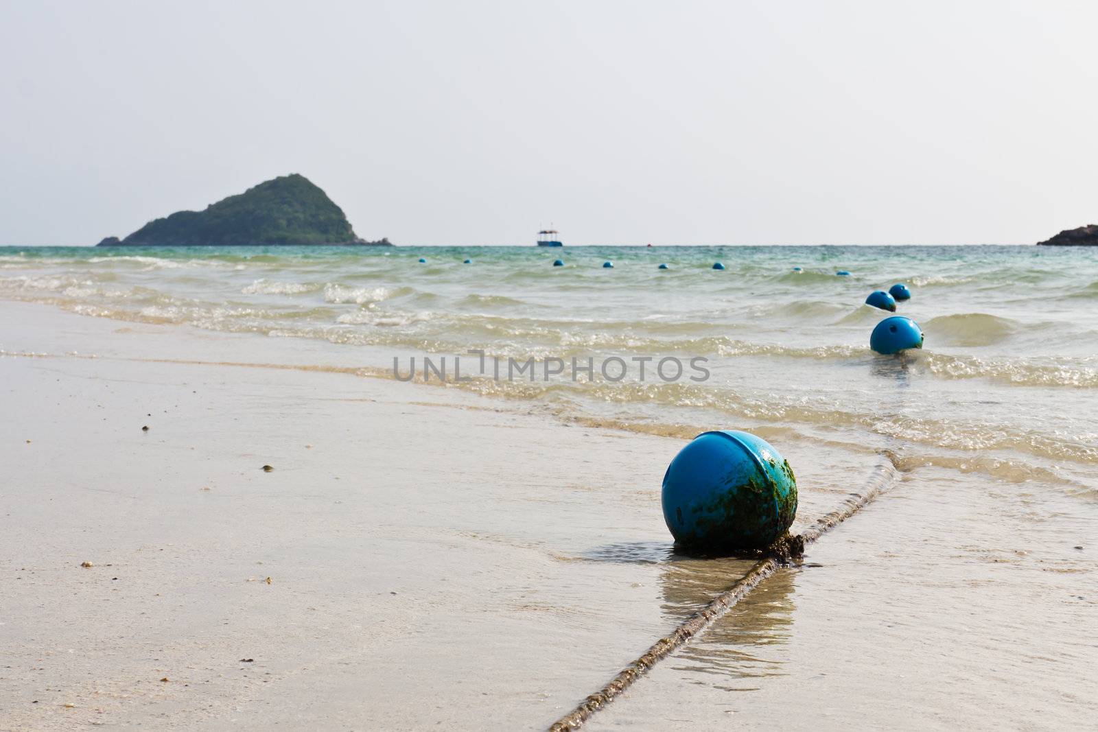 Blue buoy on the beach