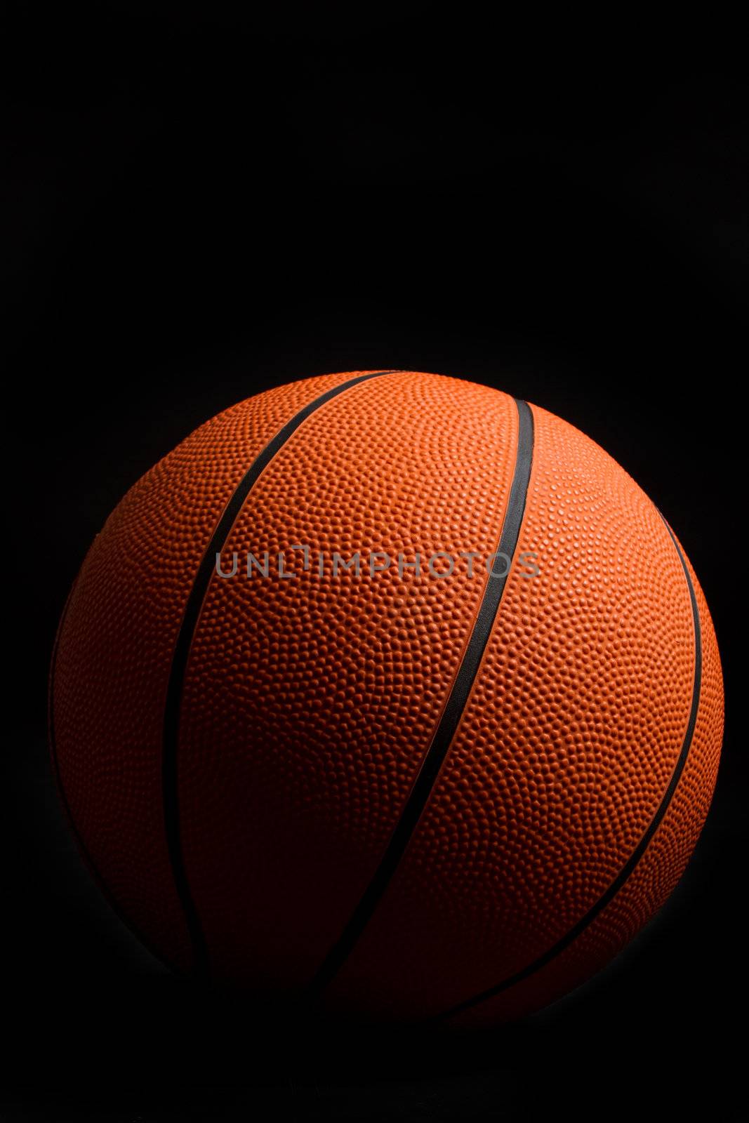 Orange basketball on black background
