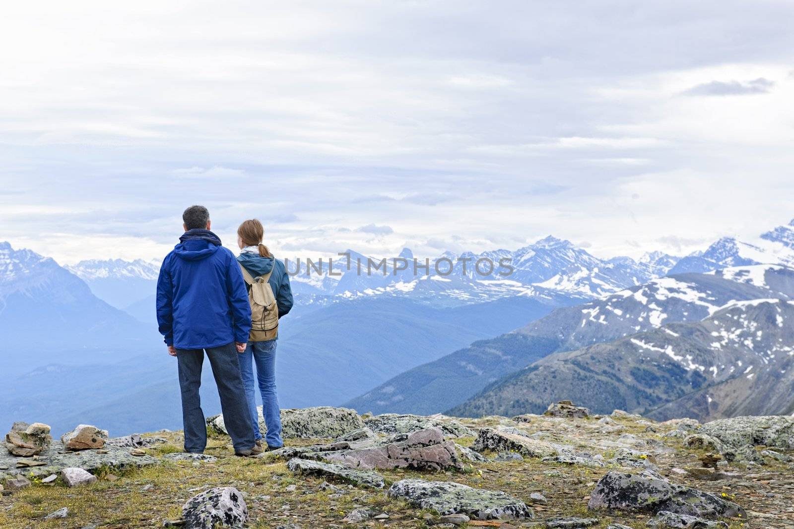 Hikers in mountains by elenathewise