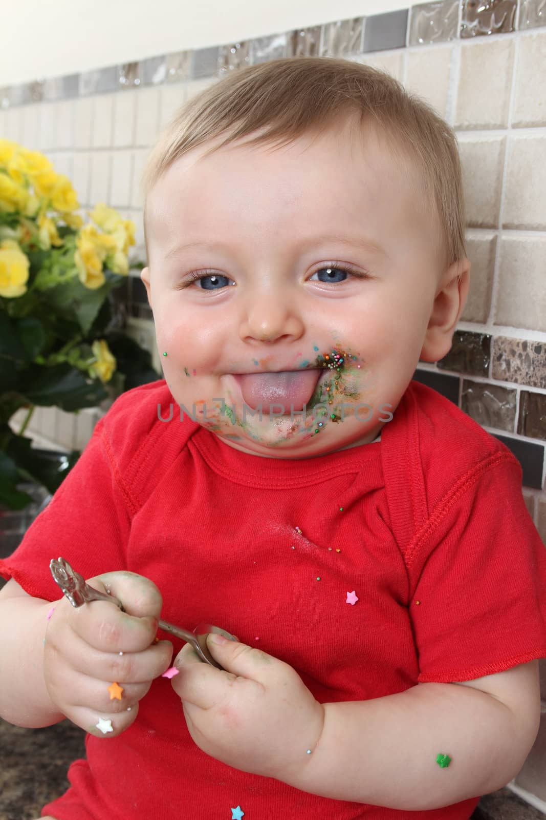 Baby boy playing on messy counter top
