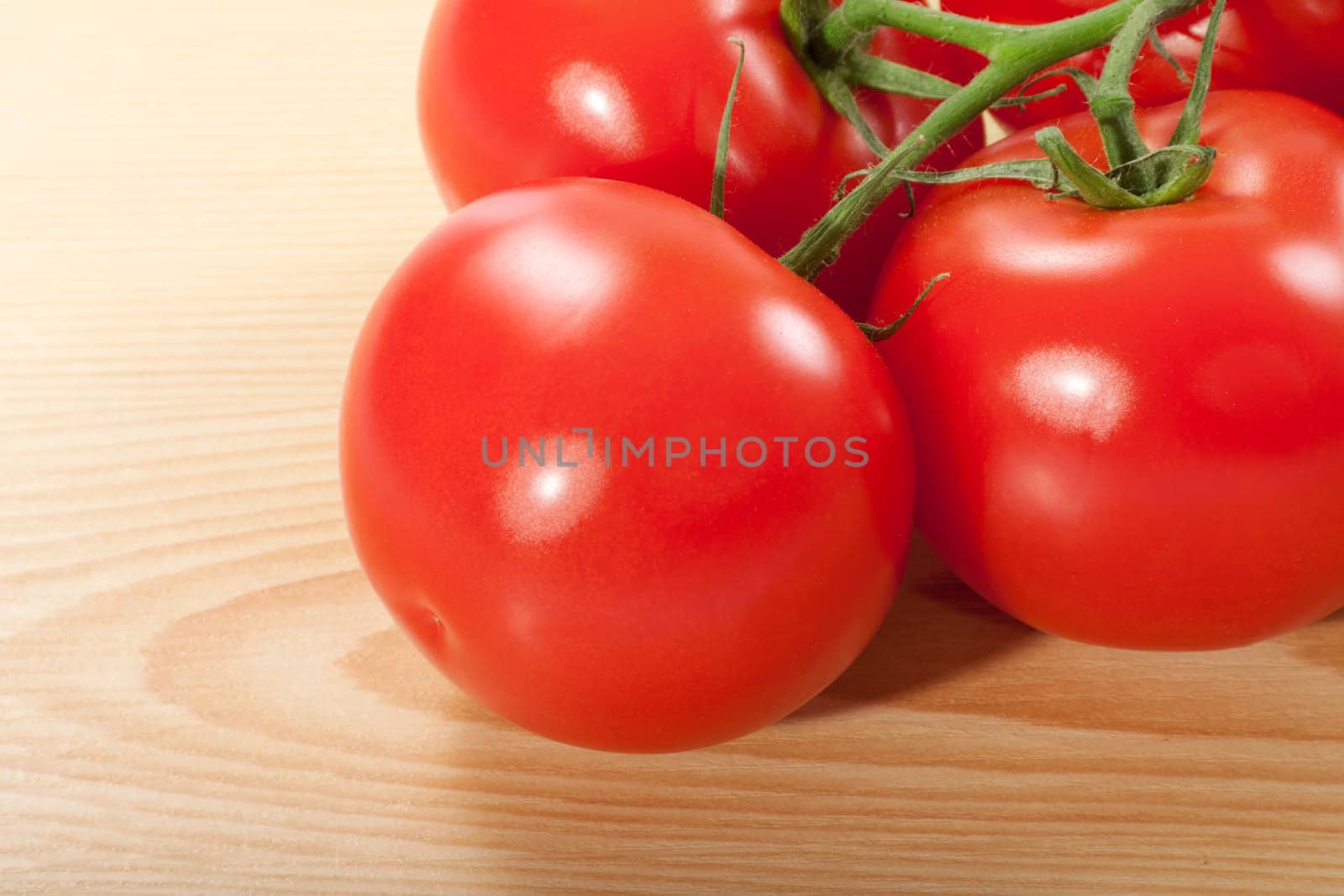 fresh red tomatoes on a wooden table