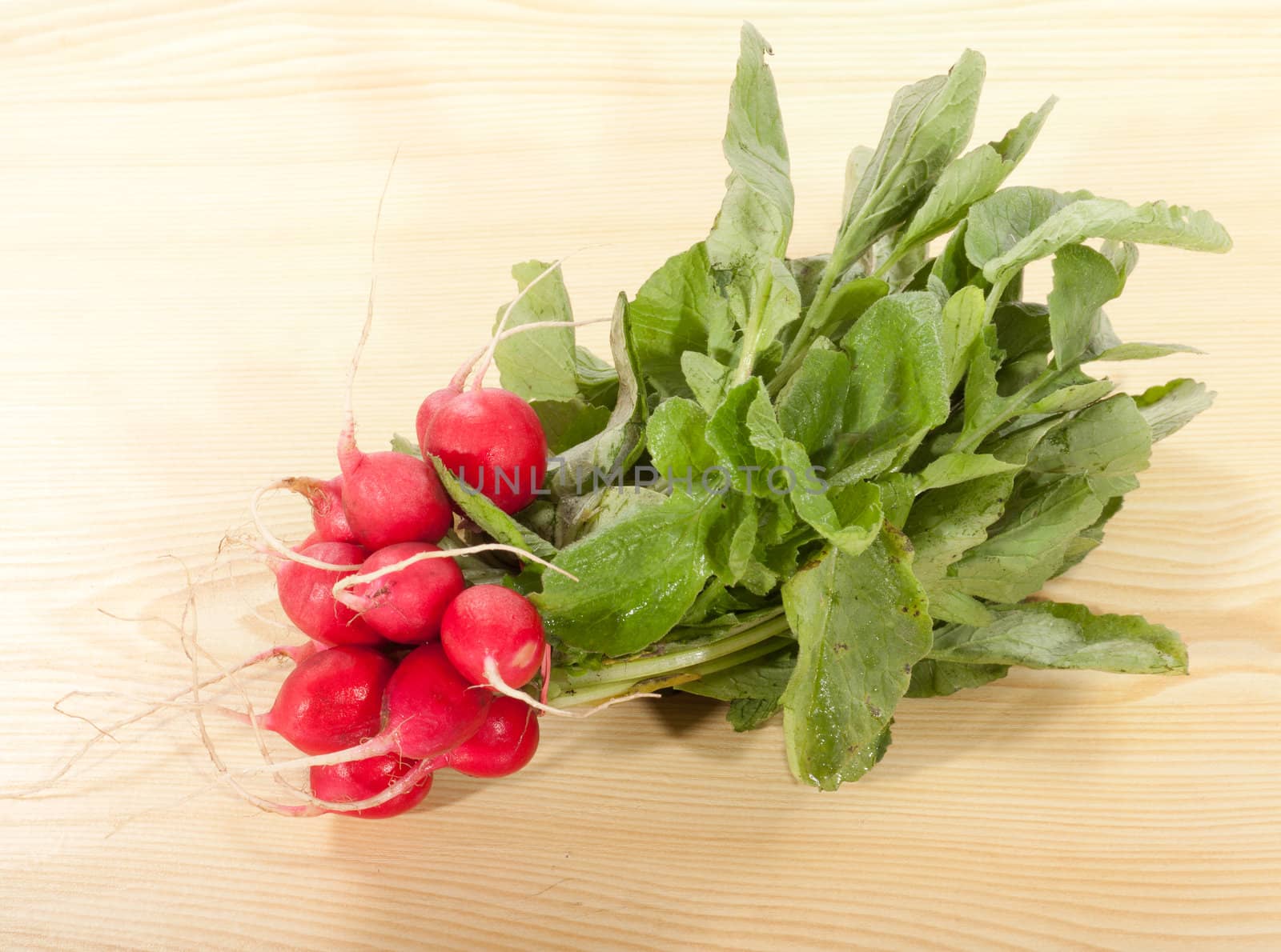 bunch of radishes on a wooden table