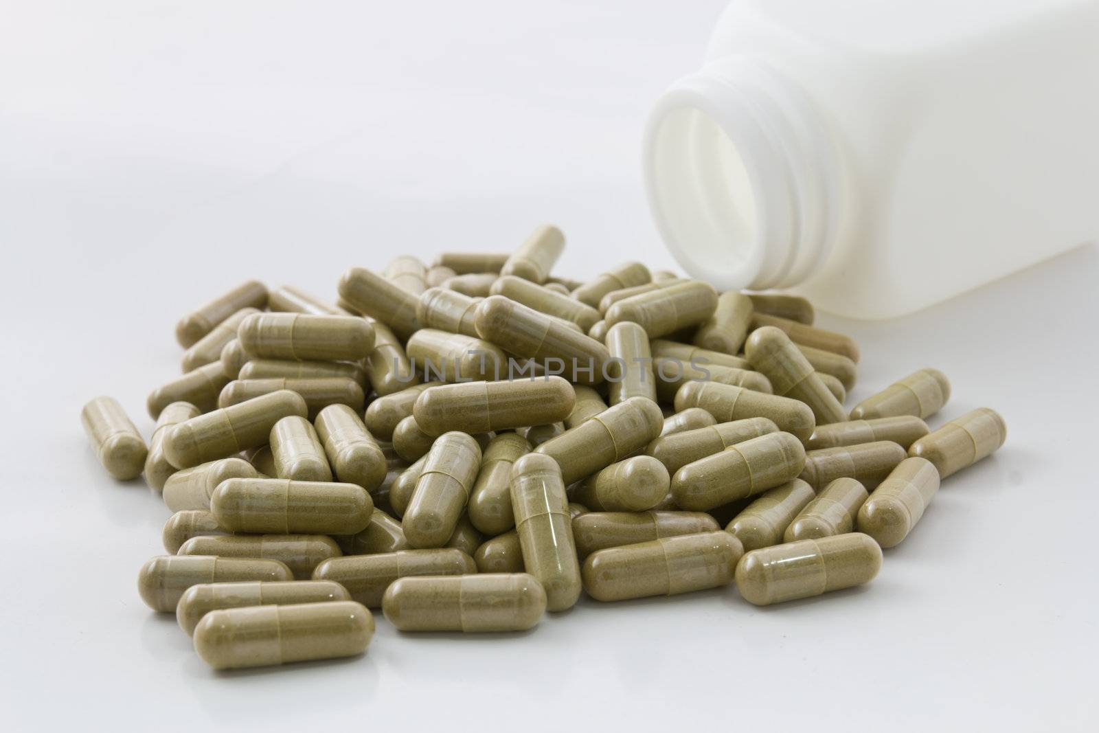 Herbal medicine capsule on white background