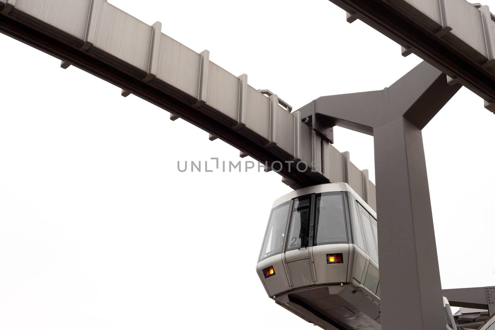 Modern public transportation system Sky-Train hanging from elevated guideway beam on columns isolated on white background