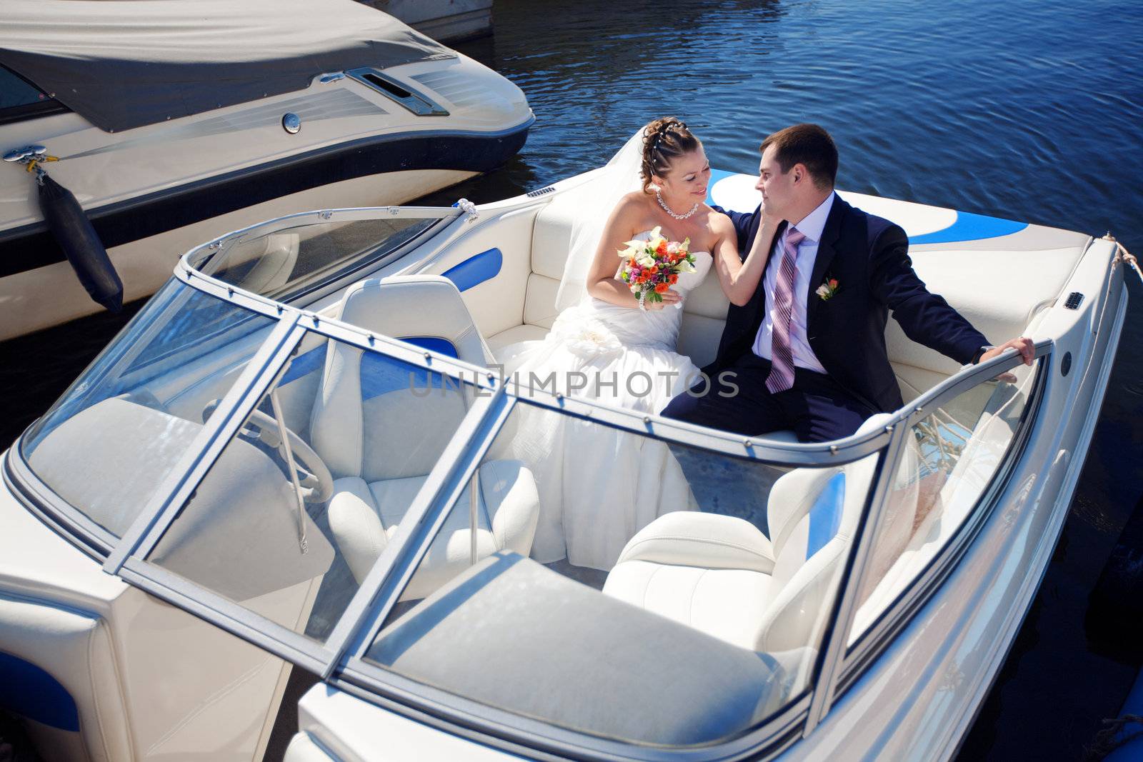 happy bride and groom on the boat