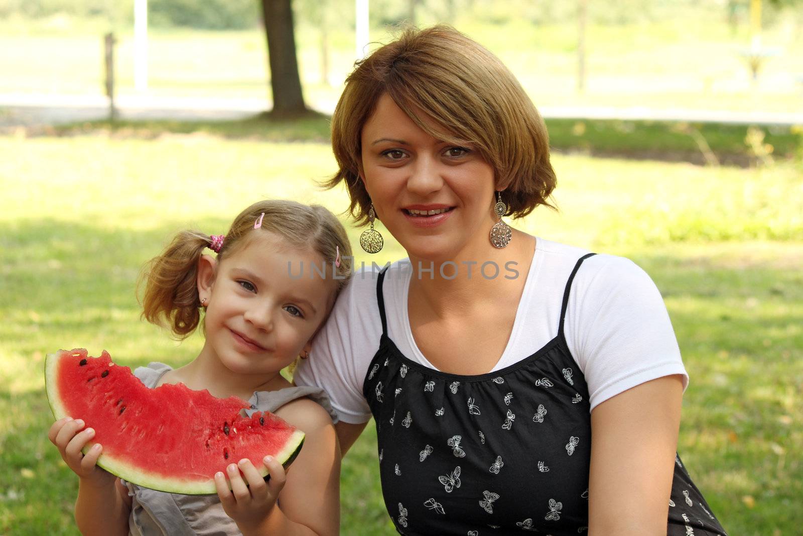 mother and daughter with watermelon by goce