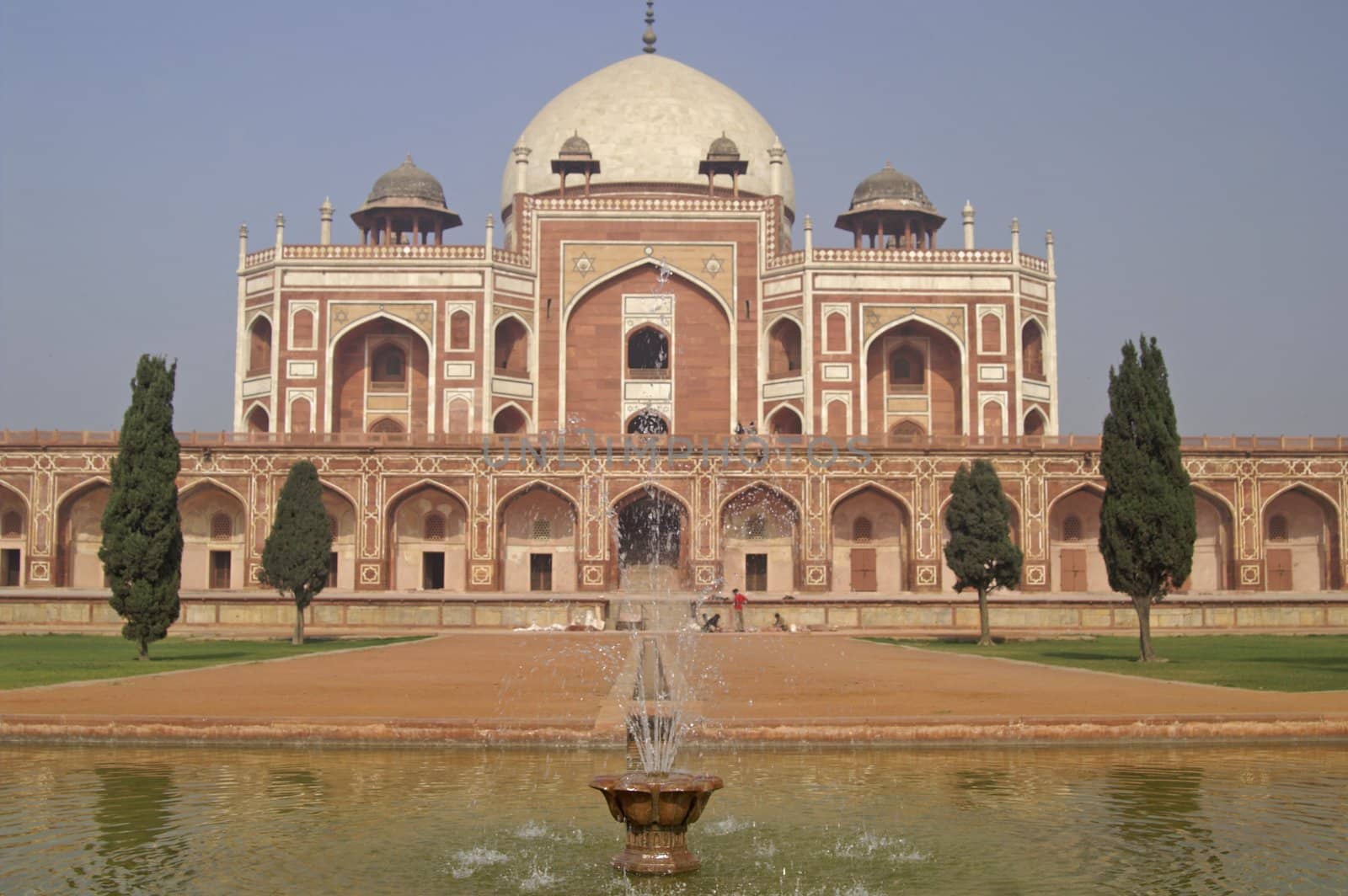 Humayun's Tomb. Islamic mausoleum. Large red sandstone building decorated with inlaid white marble and topped with white marble dome. Delhi, India