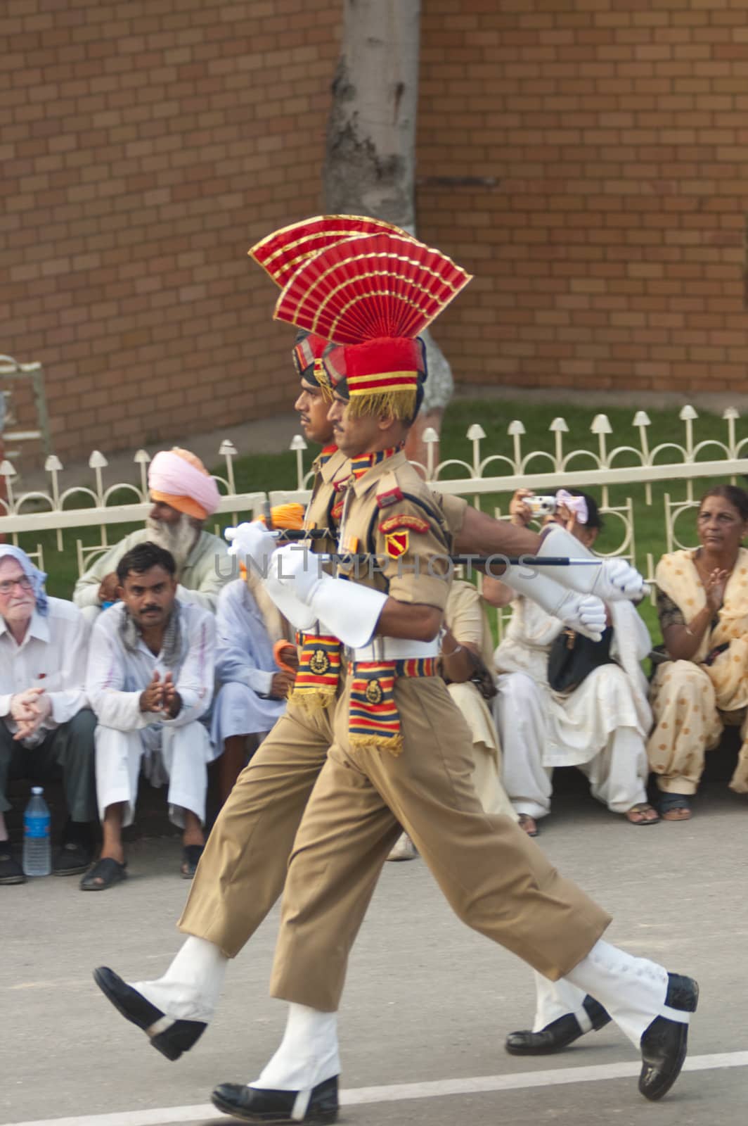 Indian soldiers in dress uniform marching as part of the ceremony closing the border between India and Pakistan at Wagah in Punjab, India