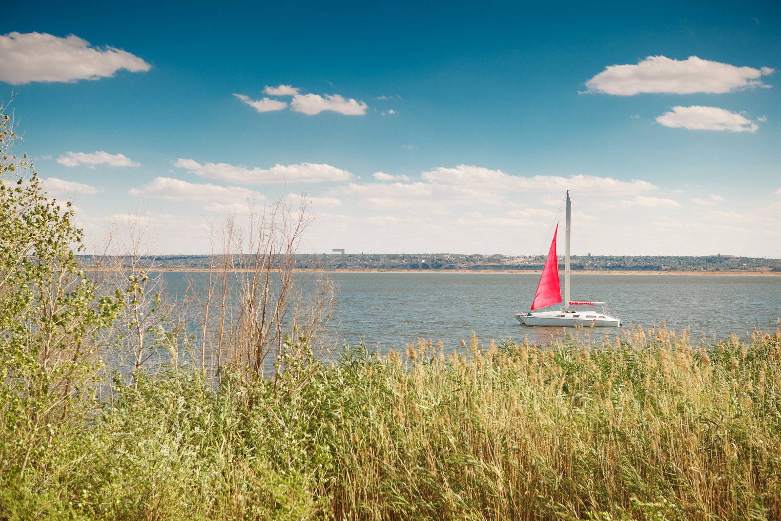 boat under the red sail in the sea