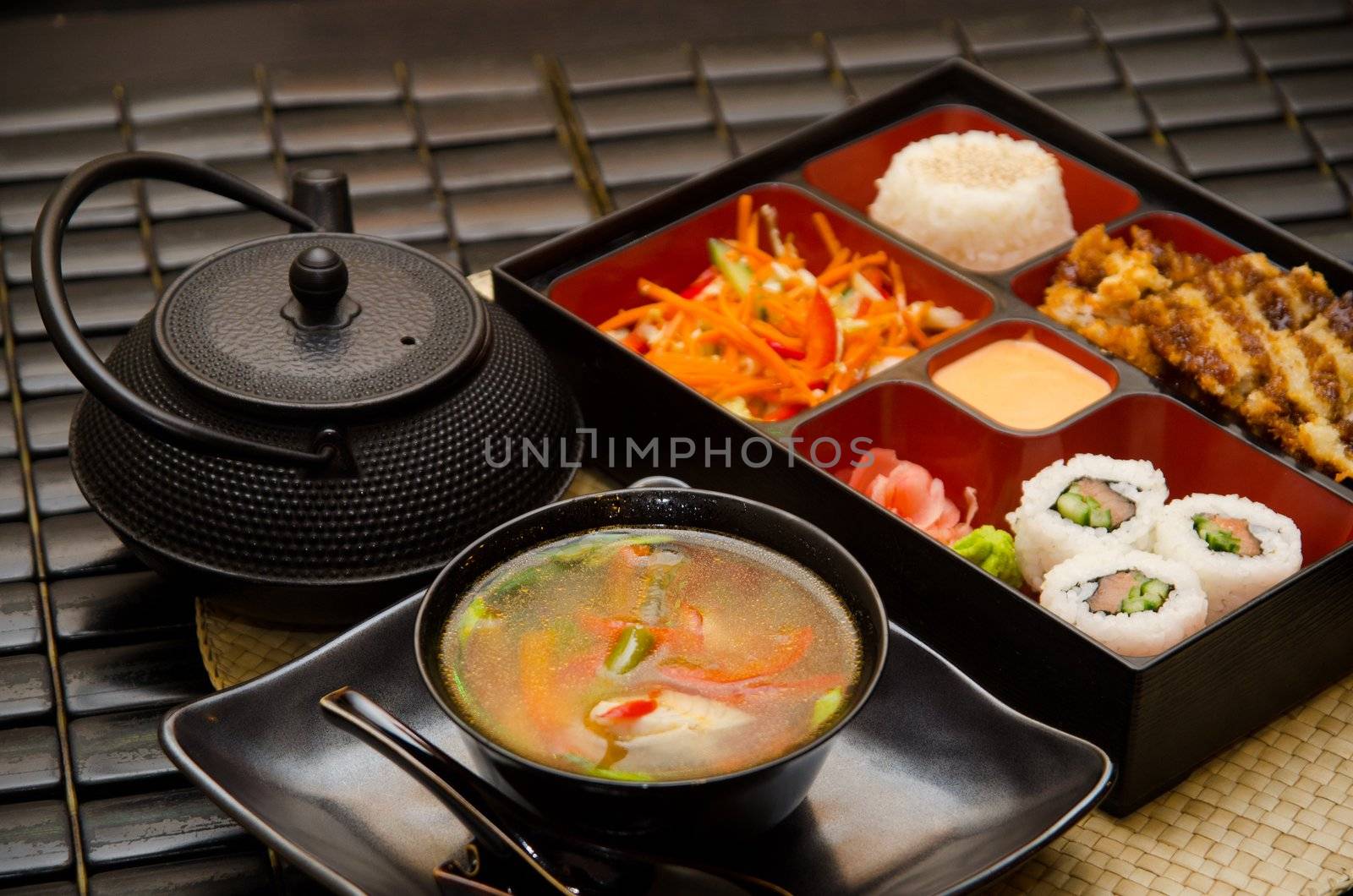 Sushi lunch with soup salad tea and sauce