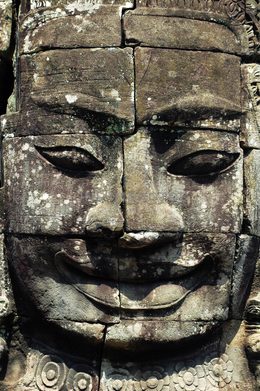 Ruins of giant smiling buddha statue at Angkor, Cambodia
