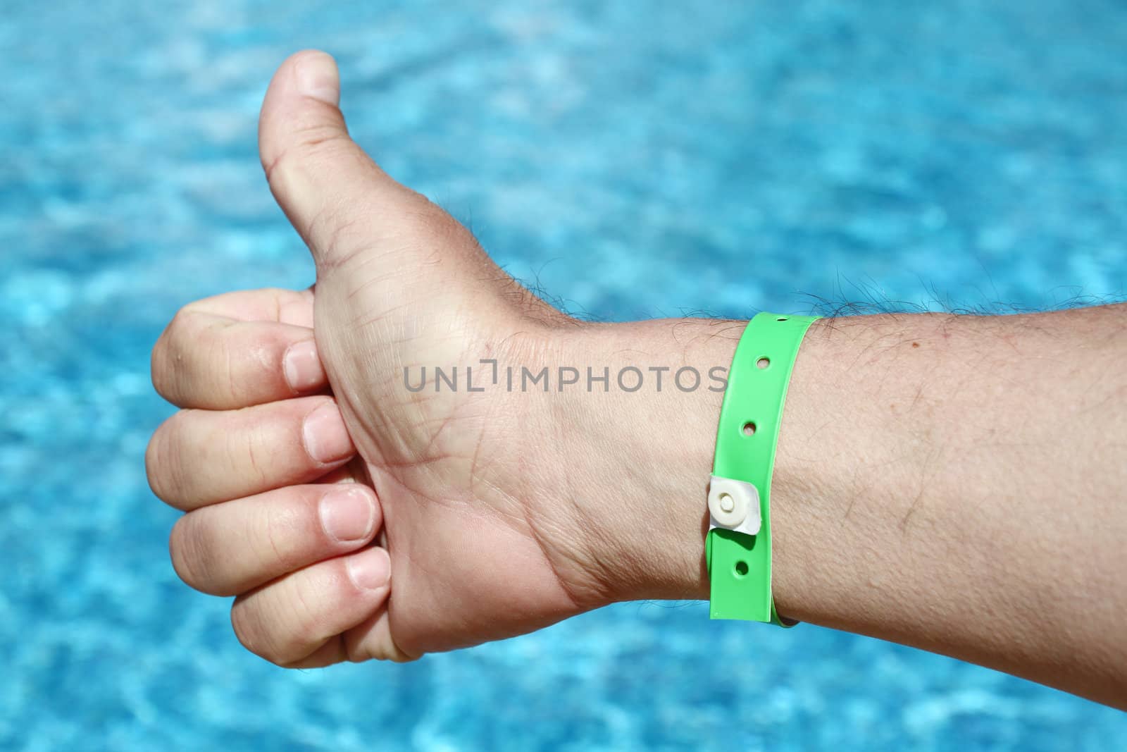 thumbs up sign over water background. Holiday concept