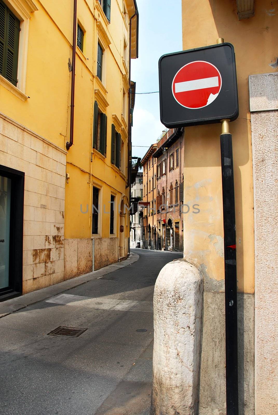 traffic sign in narrow curve street in Verona, Italy