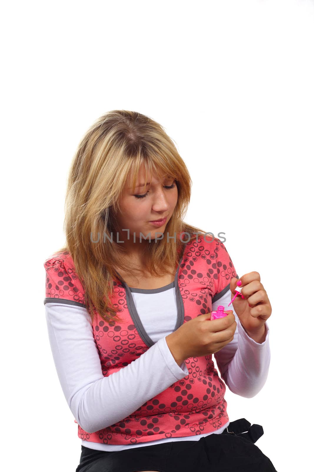 Young woman painting her nails isolated on white background