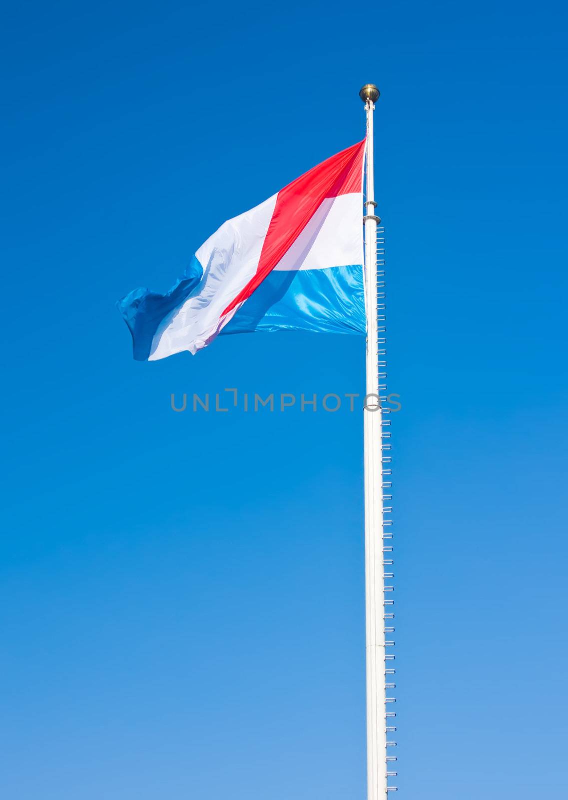 Flag of Luxembourg over blue sky. This photo is taken in Luxembourg