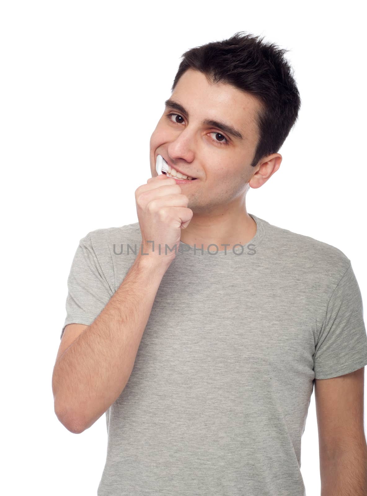 handsome young man brushing his teeth with toothbrush (isolated on white background)