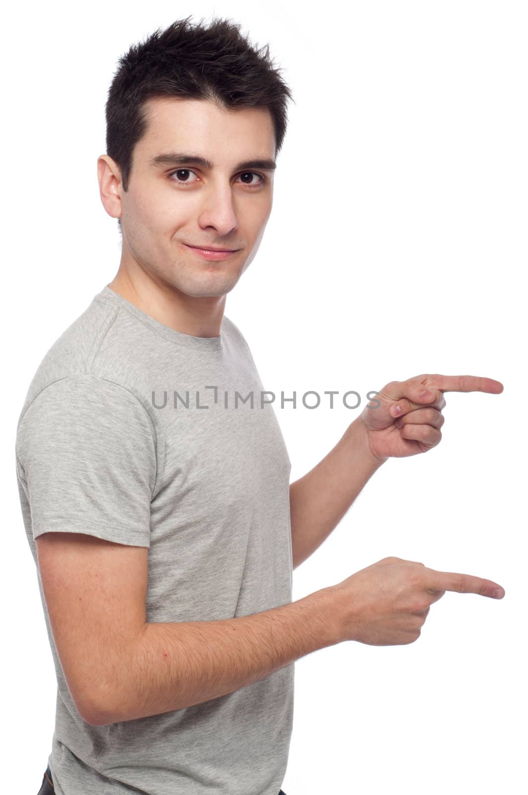 handsome young man pointing at something isolated on white background 