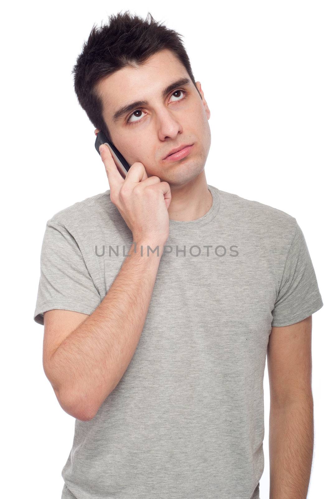 worried young casual man talking on the phone (isolated on white background)
