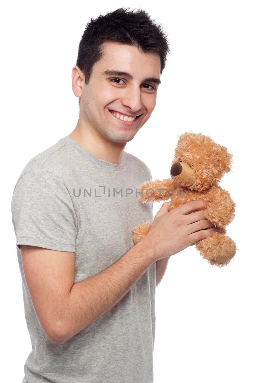 lovely portrait of a young man holding a teddy bear (isolated on white background)