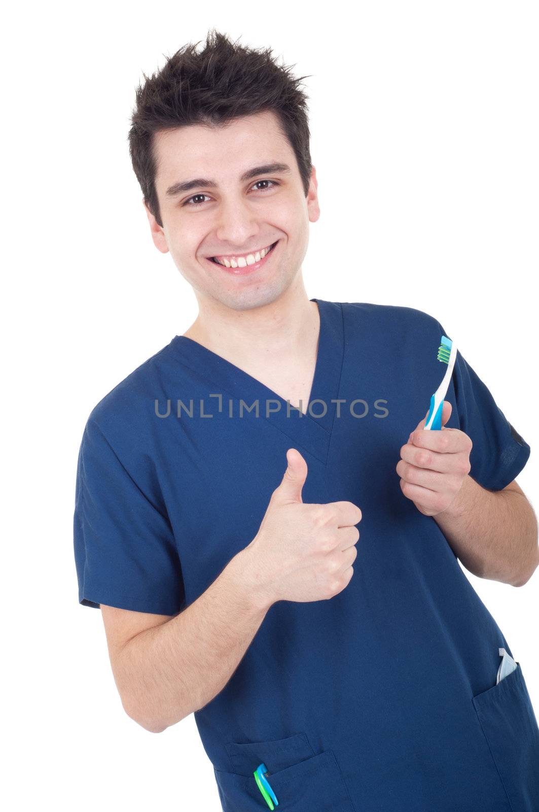 smiling male dentist holding toothbrush and showing thumb up isolated on white background