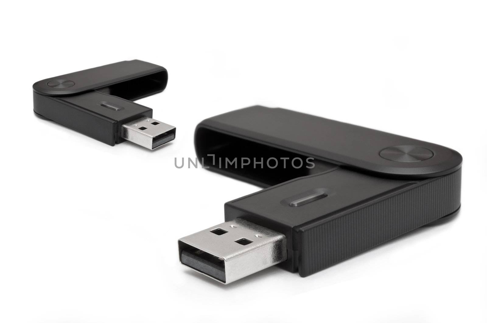 Close and low level angle capturing two black usb sd card adaptors arranged over white