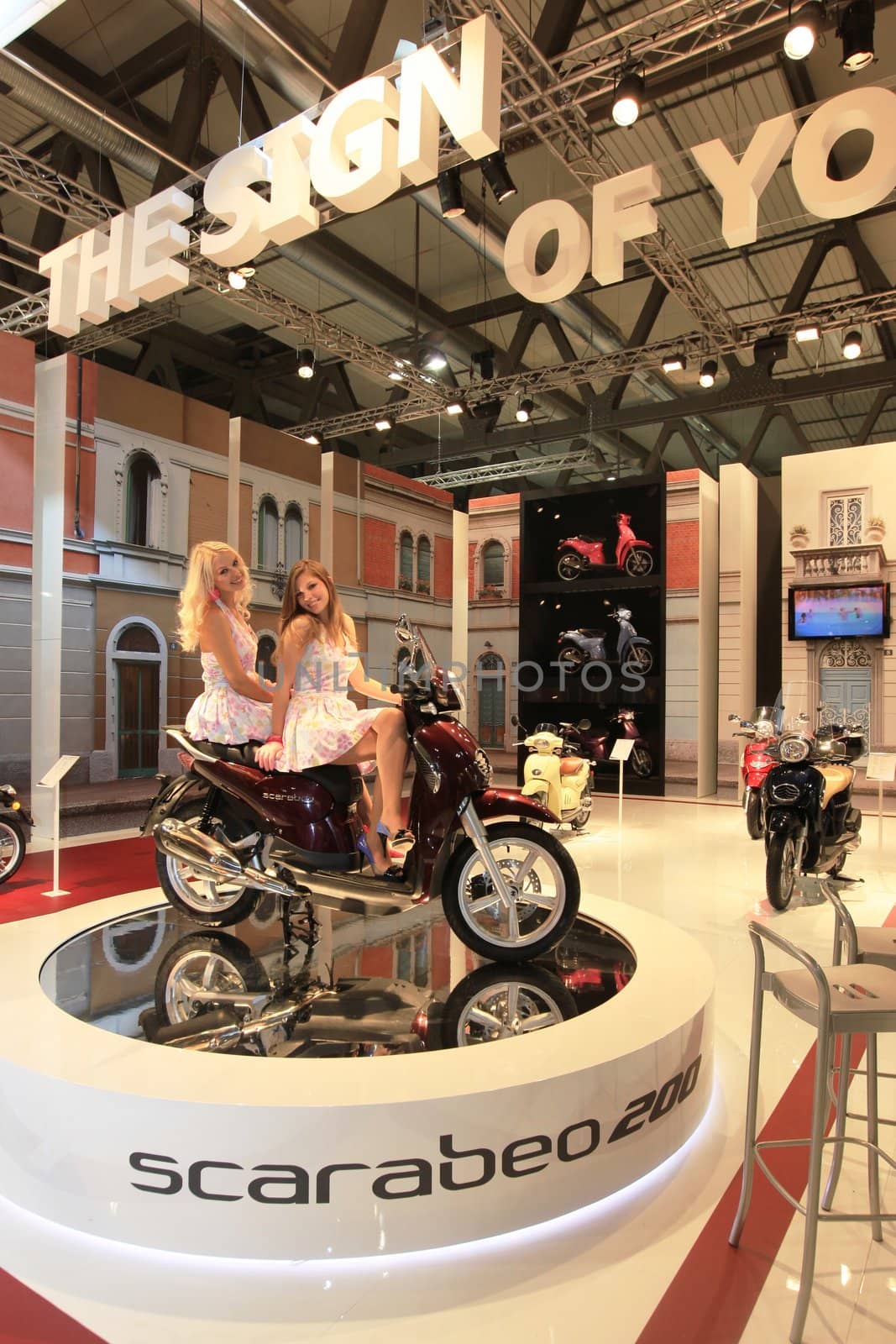 Visiting scooters and motorcycels stands during EICMA 2011, International Motorcycle Exhibition in Milan, Italy