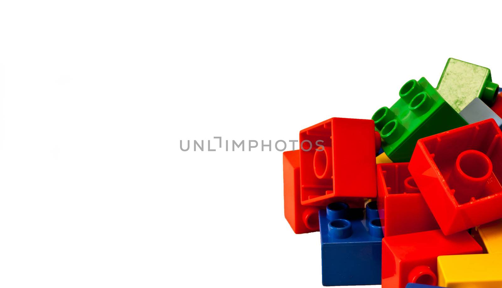 Plastic building blocks on white background. Bright colors.